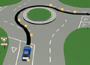 Picture of a car signalling right at a multi-laned roundabout