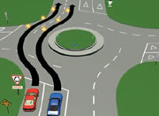 Picture of a car driving straight through a multi-laned roundabout